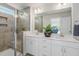 Bright bathroom featuring a glass-enclosed shower, double vanity, and modern fixtures at 211 Pond View Ct # 5, Fuquay Varina, NC 27526