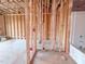 Exposed bathroom framing with rough-in plumbing, electrical wiring, and adjacent tub at 211 Pond View Ct # 5, Fuquay Varina, NC 27526