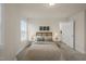 Comfortable bedroom featuring two windows, bedside tables and ensuite bathroom at 211 Pond View Ct # 5, Fuquay Varina, NC 27526