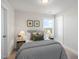Cozy bedroom featuring a comfortable bed, side tables with lamps, and a bright window at 211 Pond View Ct # 5, Fuquay Varina, NC 27526