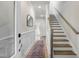 Welcoming entryway with staircase, neutral decor, and wood floors create a bright and inviting space at 211 Pond View Ct # 5, Fuquay Varina, NC 27526