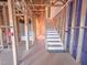 Unfinished interior with stairwell, exposed framing, and visible infrastructure at 211 Pond View Ct # 5, Fuquay Varina, NC 27526