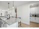 Bright kitchen featuring a large granite island with seating and a wet bar at 211 Pond View Ct # 5, Fuquay Varina, NC 27526
