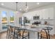 Bright kitchen featuring a large granite island with seating, stainless steel appliances, and exterior access to the deck at 211 Pond View Ct # 5, Fuquay Varina, NC 27526