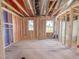 Bright unfinished interior with windows and wood framing, offering customization for personalization and design at 211 Pond View Ct # 5, Fuquay Varina, NC 27526