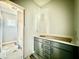 Bathroom features vanity with gray cabinets, white countertop and view of backyard at 2624 Silver Gate Ct, Wake Forest, NC 27587