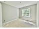 Sunlit bedroom features neutral walls and a large window overlooking a wooded area at 2624 Silver Gate Ct, Wake Forest, NC 27587