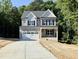 Two-story home featuring a two-car garage, a covered front porch, and a beautifully landscaped yard at 2624 Silver Gate Ct, Wake Forest, NC 27587