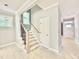 Inviting foyer features stairs with iron spindles, trim detail and natural light at 2624 Silver Gate Ct, Wake Forest, NC 27587