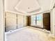Living room with decorative paneled walls, large window, tray ceiling, and unfinished floors at 2624 Silver Gate Ct, Wake Forest, NC 27587