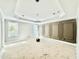Bright, spacious room features custom wall panels, tray ceiling, and ample windows at 2624 Silver Gate Ct, Wake Forest, NC 27587