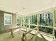 Covered, screened back porch with wood decking and view to trees in the back yard at 2624 Silver Gate Ct, Wake Forest, NC 27587