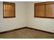 This cozy bedroom features neutral walls and two windows, each fitted with wood blinds at 608 N Ellis Ave, Dunn, NC 28334