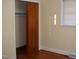 This bedroom features a closet with wood sliding doors and hardwood floors at 608 N Ellis Ave, Dunn, NC 28334