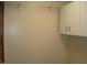 A view of a bedroom closet featuring white walls, a wire shelf, and upper cabinets at 608 N Ellis Ave, Dunn, NC 28334