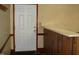 This home features an entryway with a white door, wooden bar counter, and neutral-toned wallpaper at 608 N Ellis Ave, Dunn, NC 28334