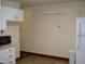 This kitchen is equipped with classic white cabinets, a refrigerator, and a microwave at 608 N Ellis Ave, Dunn, NC 28334