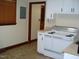 The kitchen features white cabinets and a classic stove and sink at 608 N Ellis Ave, Dunn, NC 28334