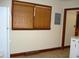 A view of the kitchen window, with wood trim and horizontal blinds at 608 N Ellis Ave, Dunn, NC 28334