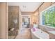 Bathroom with glass shower, freestanding tub, vanity, and view into main bedroom at 3177 Armeria Dr, Apex, NC 27502