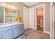 Modern bathroom with double vanity, walk-in closet, and glass shower door at 3177 Armeria Dr, Apex, NC 27502