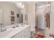 Bright bathroom featuring a double vanity, decorative mirror, and modern fixtures at 3177 Armeria Dr, Apex, NC 27502