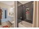 Modern bathroom showcasing sleek black tiled shower with built-in niche and contemporary fixtures at 3177 Armeria Dr, Apex, NC 27502