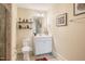 Modern bathroom features white vanity, framed mirror, and stylish shelves for a clean, contemporary look at 3177 Armeria Dr, Apex, NC 27502