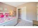 Cozy bedroom with a bed with a white studded headboard and doorway leading to a closet at 3177 Armeria Dr, Apex, NC 27502