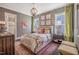 Comfortable bedroom with chandelier lighting, plush bedding, and ample natural light at 3177 Armeria Dr, Apex, NC 27502