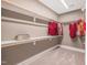 Walk-in closet with custom shelving and organized storage for clothing and personal belongings at 3177 Armeria Dr, Apex, NC 27502