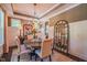 Bright dining room boasting natural light, a modern chandelier, and seating for six around a wood table at 3177 Armeria Dr, Apex, NC 27502