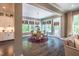 Sunlit dining area with backyard view and stylish chandelier fixture at 3177 Armeria Dr, Apex, NC 27502