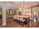 Open-concept kitchen featuring a large island with seating, modern pendants, and stainless steel appliances at 3177 Armeria Dr, Apex, NC 27502