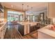 Modern kitchen showcasing a large island with bar seating, stainless appliances, and an open-concept design at 3177 Armeria Dr, Apex, NC 27502