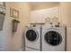 Well-organized laundry room featuring modern white appliances and ample storage space for convenience at 3177 Armeria Dr, Apex, NC 27502