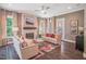 Inviting living room featuring a stone fireplace, hardwood floors, and natural light at 3177 Armeria Dr, Apex, NC 27502
