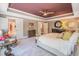 Main bedroom with tray ceiling, plush carpet, upholstered bed, and doorways to other rooms at 3177 Armeria Dr, Apex, NC 27502