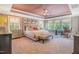 Spacious main bedroom with tray ceiling, upholstered bed, plush carpet, and bright windows at 3177 Armeria Dr, Apex, NC 27502