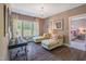 Home office area featuring hardwood floors, a desk, and comfortable chaise lounges near a window at 3177 Armeria Dr, Apex, NC 27502