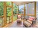 Serene sunroom offers comfortable seating and beautiful outdoor views for relaxation and enjoyment at 3177 Armeria Dr, Apex, NC 27502