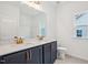Well-lit bathroom featuring a dual sink vanity and large mirror, complemented by a window at 3301 Oakfields Rd # 2, New Hill, NC 27562