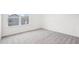 Bright bedroom with white walls and carpet, featuring a window with a view of neighboring homes at 3301 Oakfields Rd # 2, New Hill, NC 27562