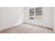 Minimalist bedroom with neutral carpet, large window overlooking the backyard, and white walls at 3301 Oakfields Rd # 2, New Hill, NC 27562