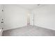 Neutral bedroom featuring carpet, white walls, a doorway, and plenty of space at 3301 Oakfields Rd # 2, New Hill, NC 27562