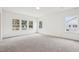 Large bedroom with carpet, white walls, large window and construction views out the windows at 3301 Oakfields Rd # 2, New Hill, NC 27562