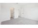 Bright bedroom featuring plush carpet, two open doors, and freshly painted white walls at 3301 Oakfields Rd # 2, New Hill, NC 27562