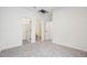 Neutral bedroom featuring carpet, white walls, and multiple doorways leading to other areas at 3301 Oakfields Rd # 2, New Hill, NC 27562