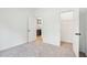 Cozy bedroom with plush carpet, closet, and view of a kitchen with stainless steel appliances at 3301 Oakfields Rd # 2, New Hill, NC 27562