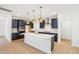 Open kitchen with gray cabinets, stainless appliances, and island with quartz countertop at 3301 Oakfields Rd # 2, New Hill, NC 27562